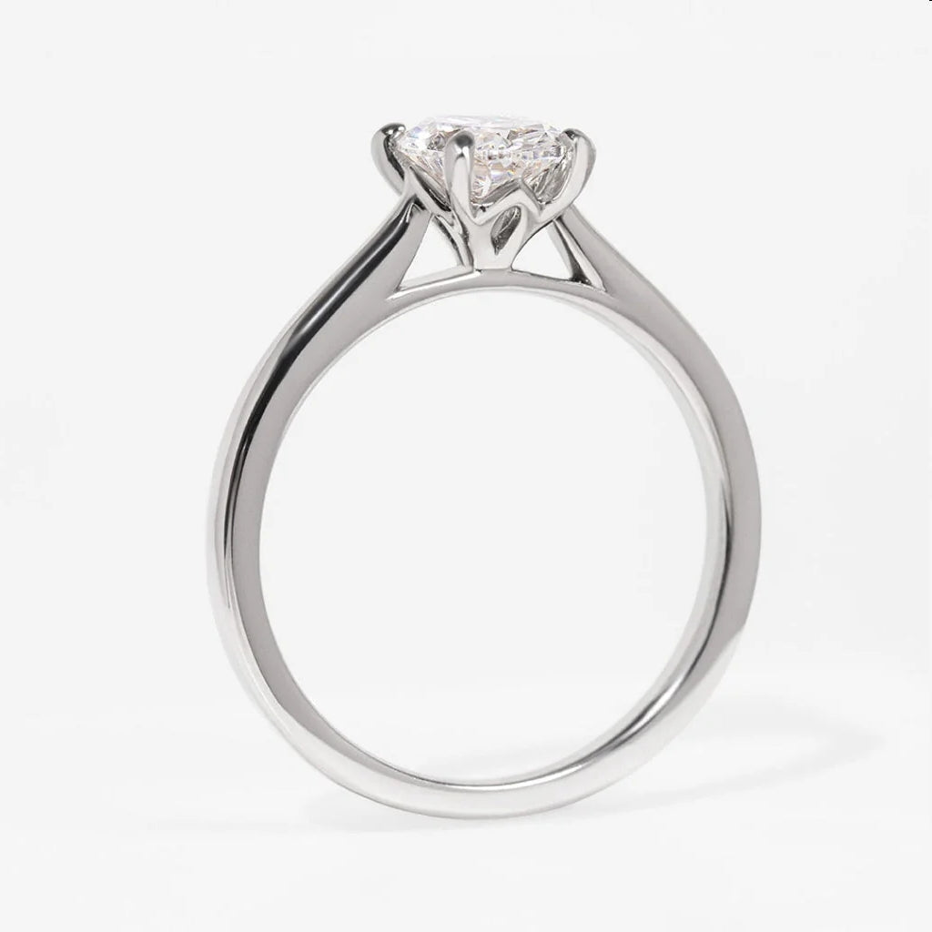Platinum natural diamond solitaire on grey background side view