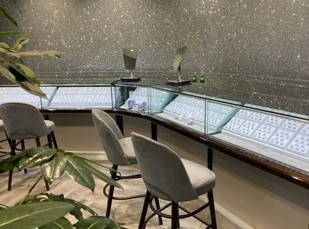 Curved display counter with glass cases containing jewelry or valuables.