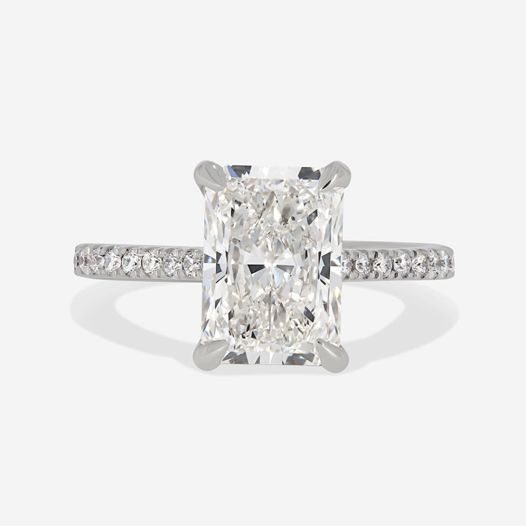 Radiant cut lab grown diamond engagement ring on grey background