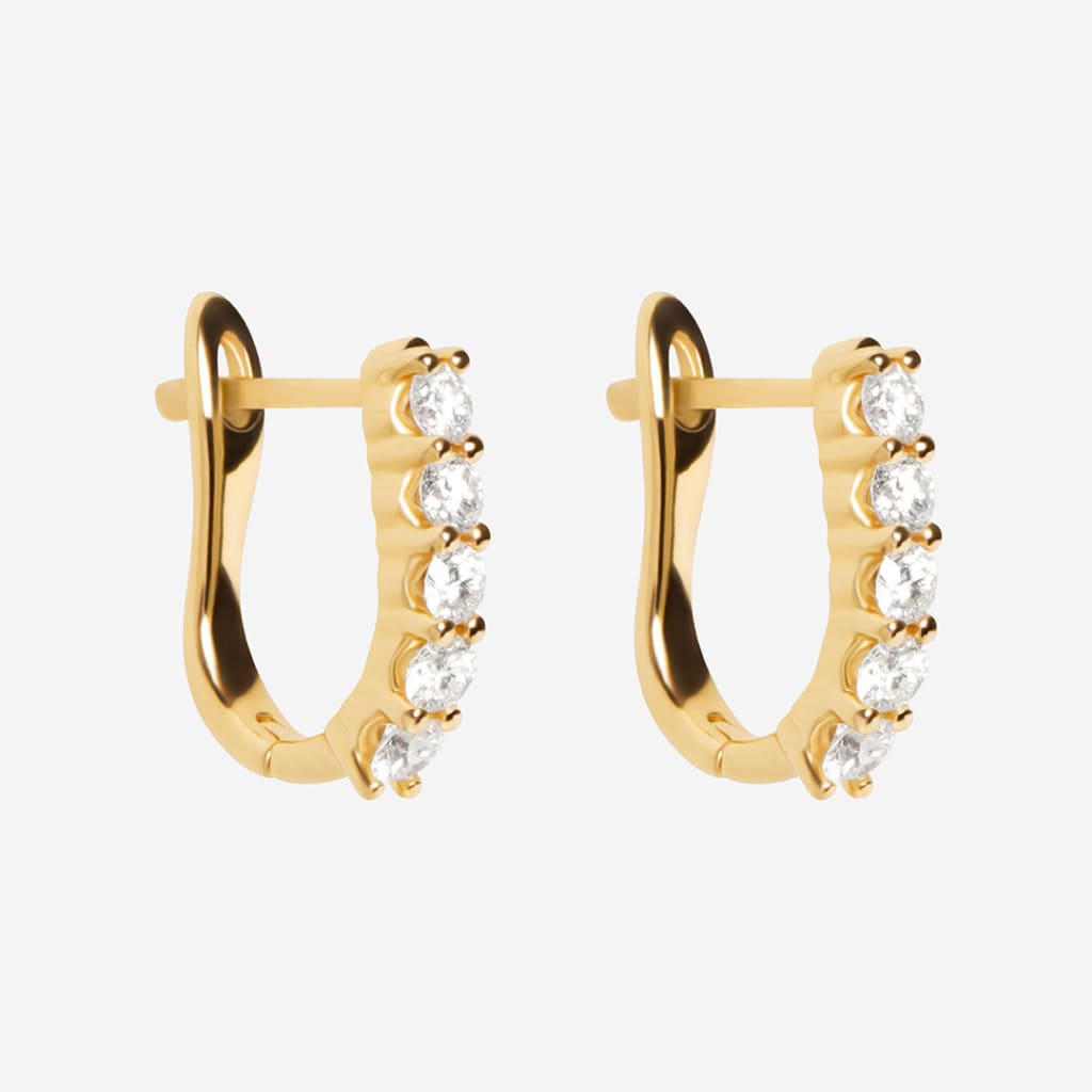 yellow gold diamond huggies on white background