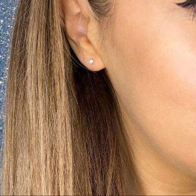 Woman wearing diamond earring.