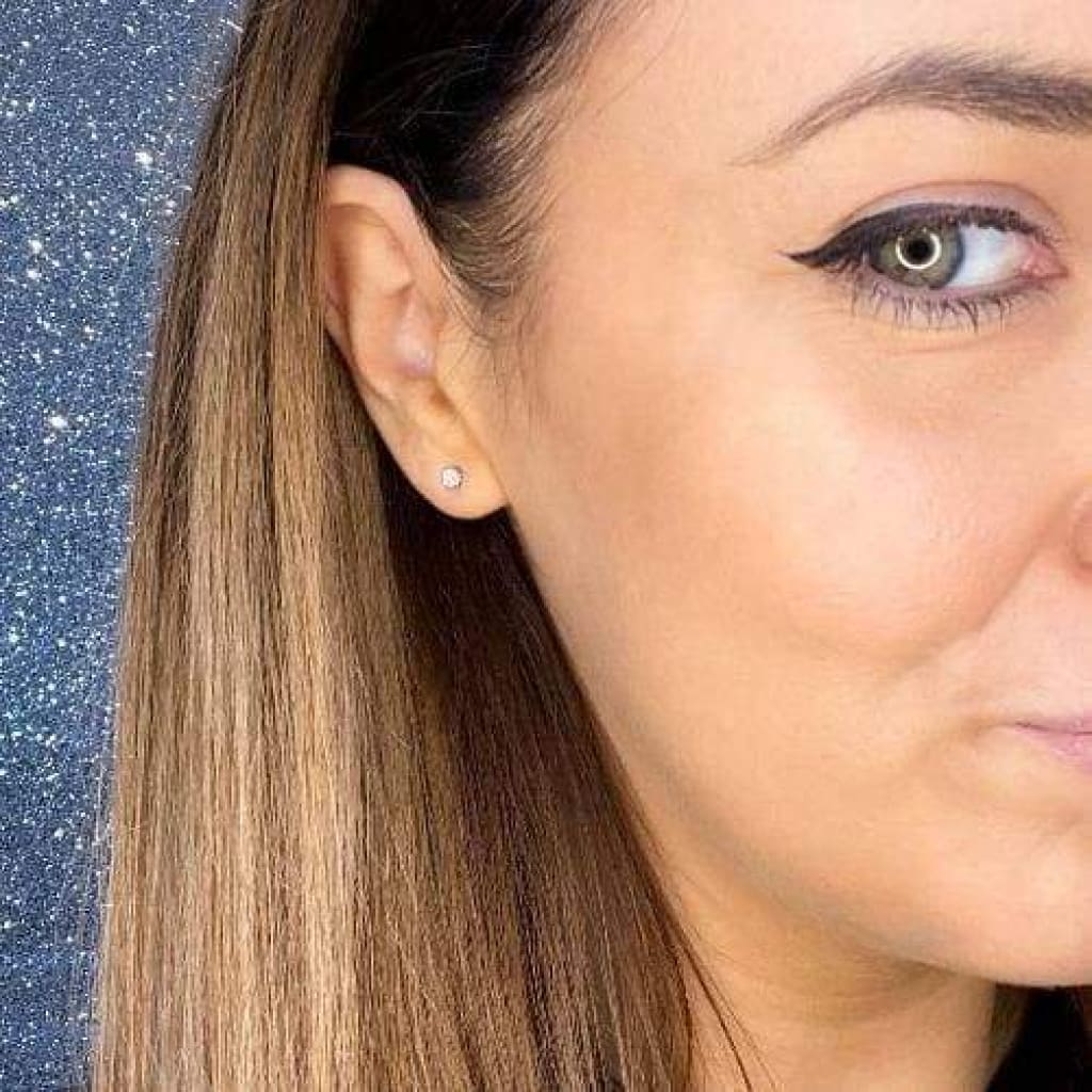 Woman wearing diamond earring.