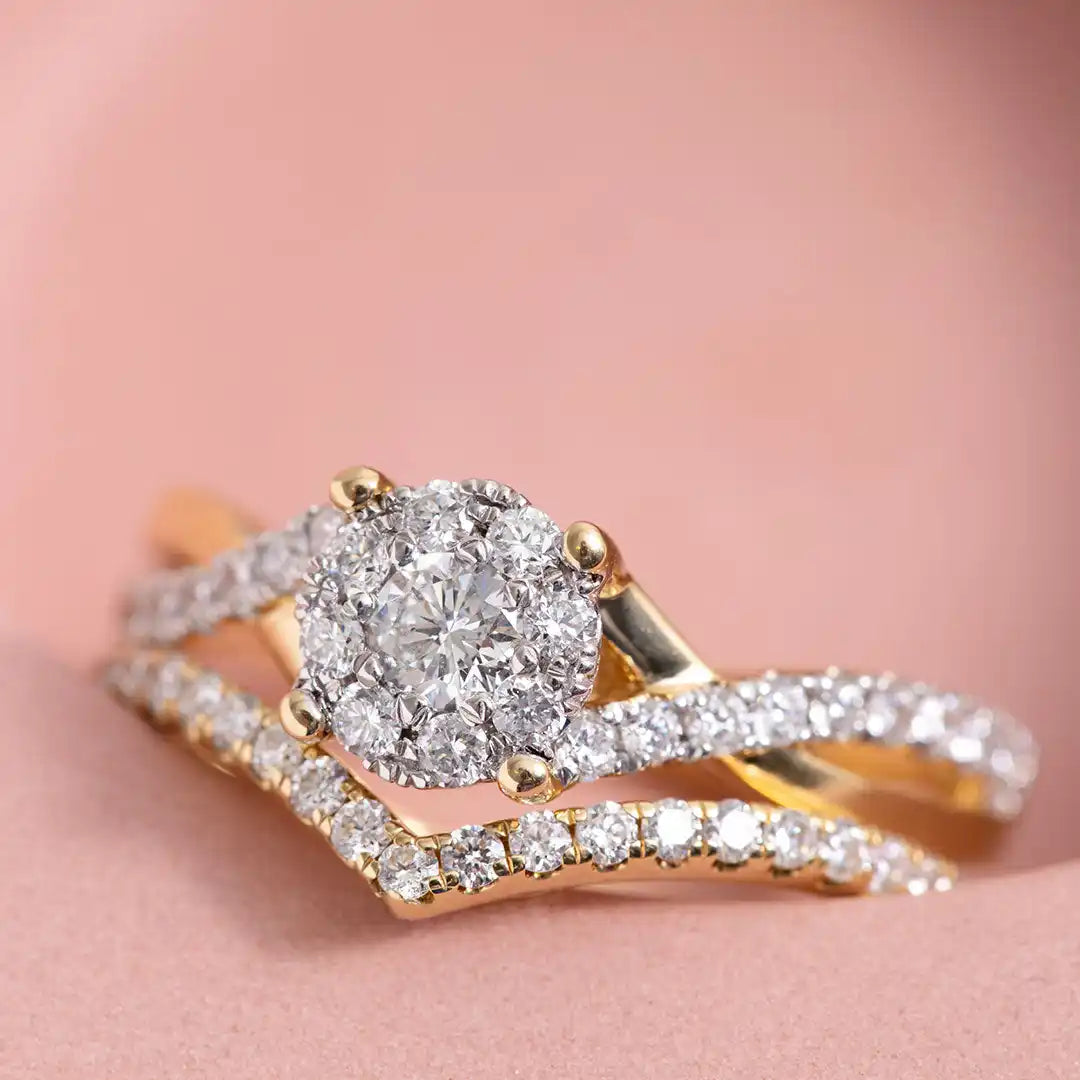 Sparkling diamond engagement ring with a chevron-shaped band in yellow gold.