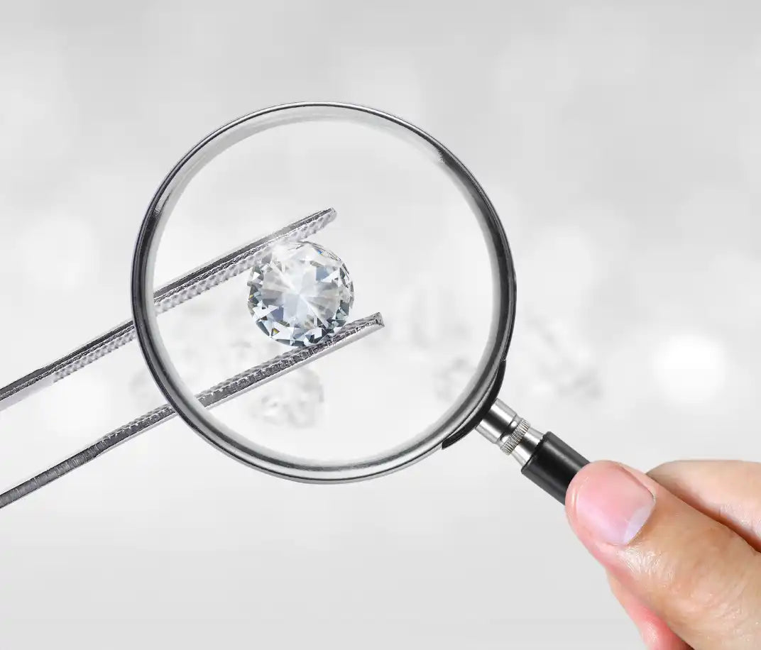 Diamond being examined through a magnifying glass.