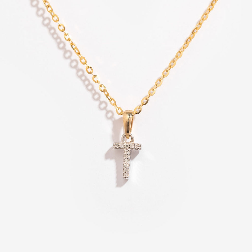 Mini diamond initial necklace on a gold chain