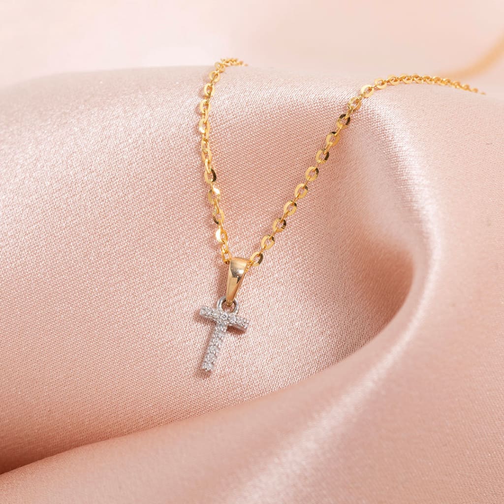 Mini diamond initial necklace on a gold chain
