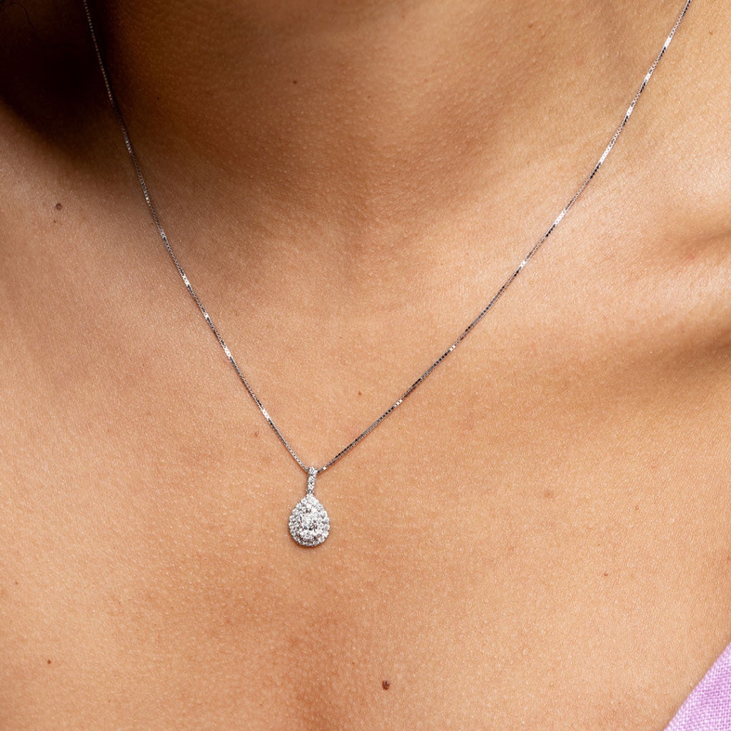Model wearing white gold pear diamond necklace close up