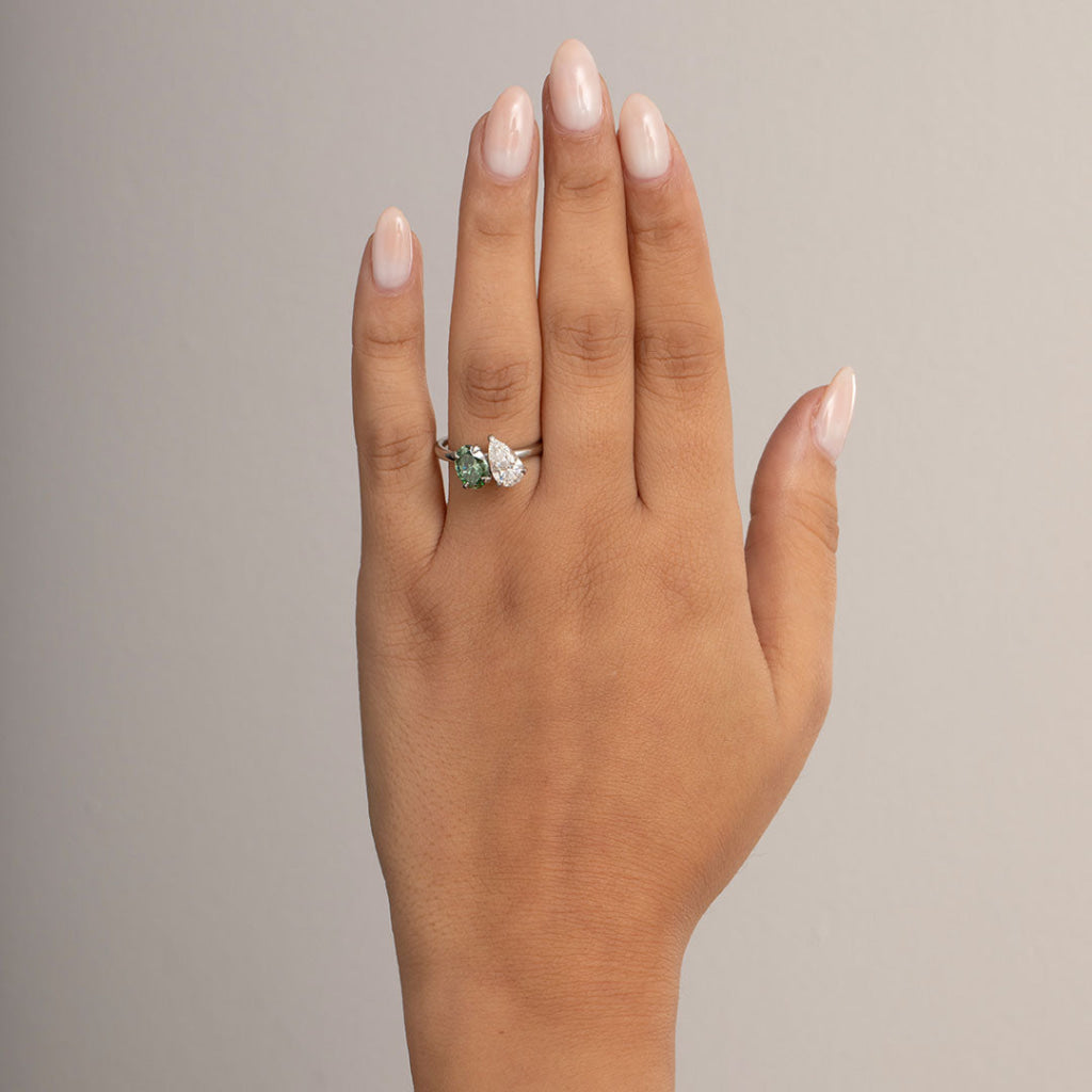 hand shot of platinum pear oval engagement ring