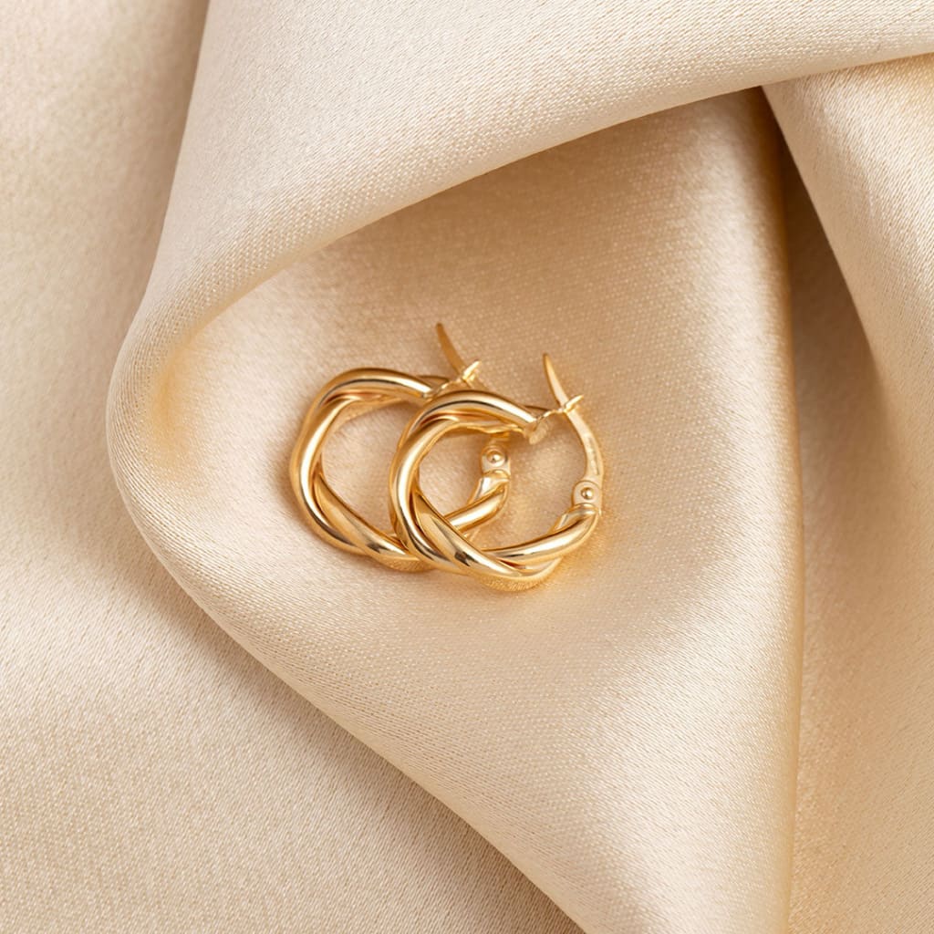 Fierce hoop earrings flat on fabric