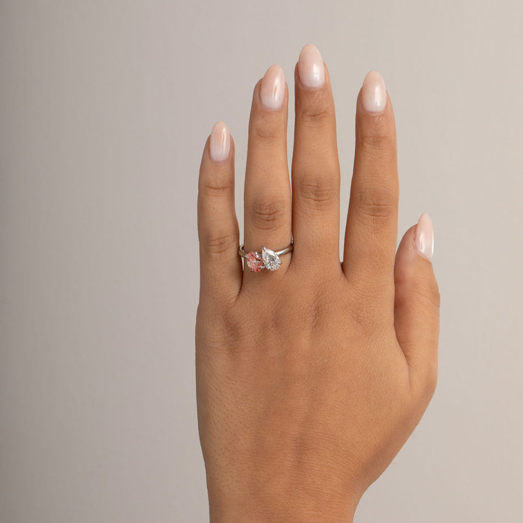 model wearing oval and pear engagement ring