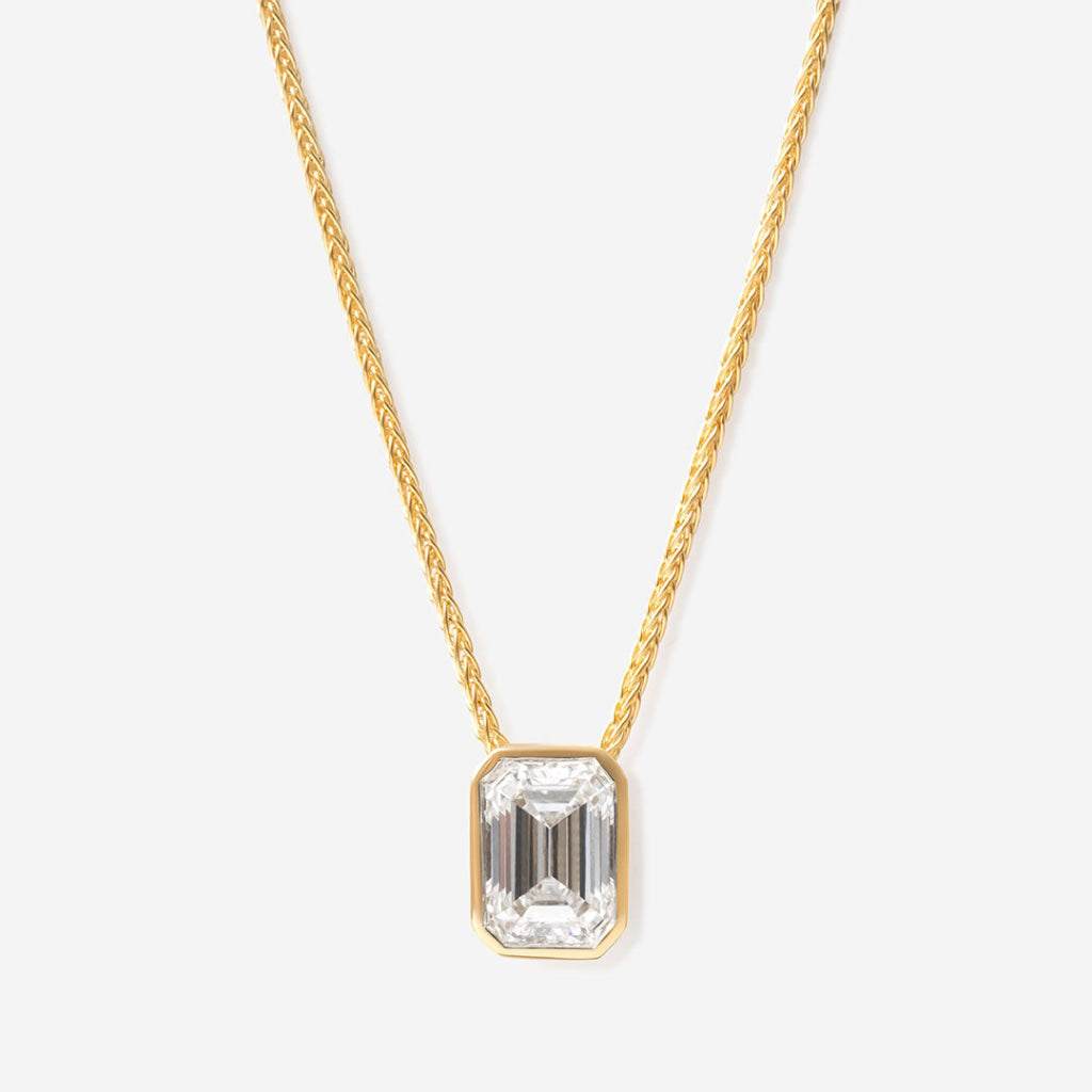Emerald cut diamond necklace on white back