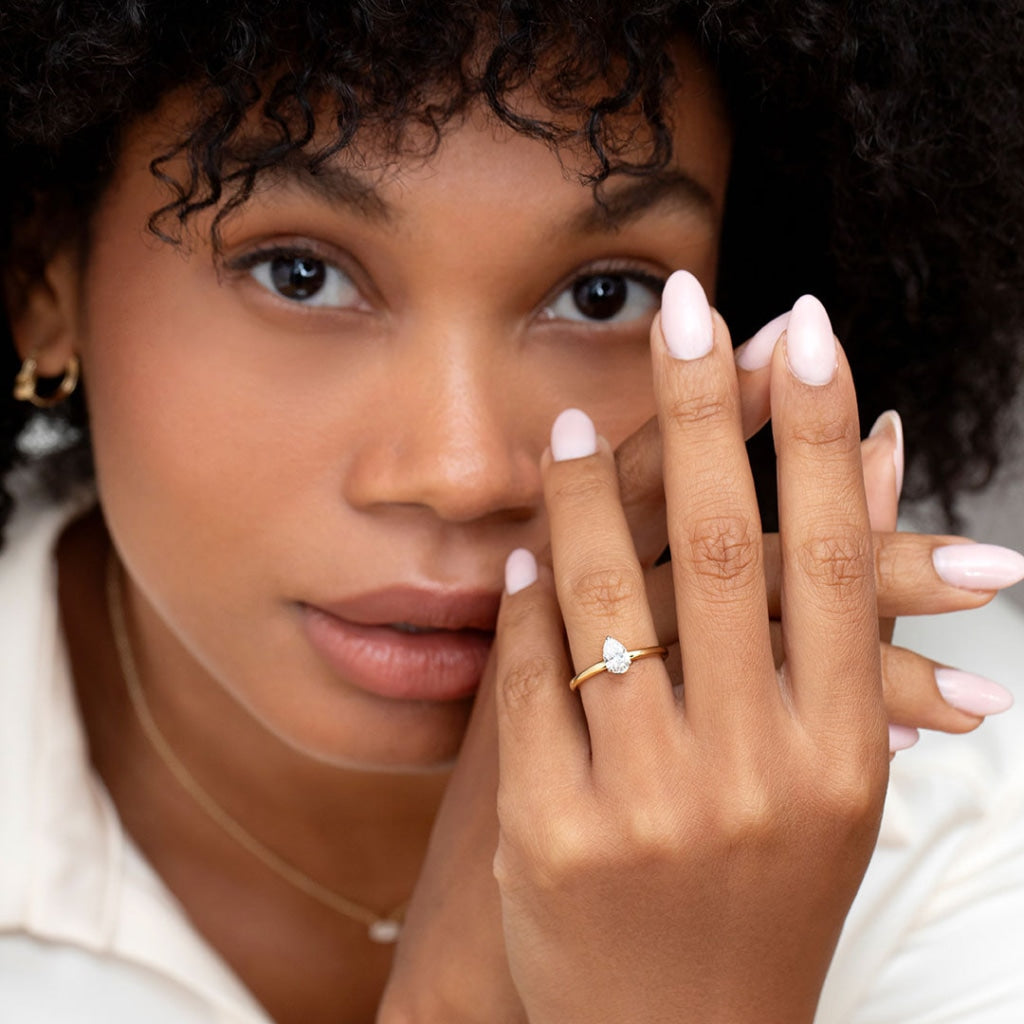Model wearing Heston pear diamond engagement ring