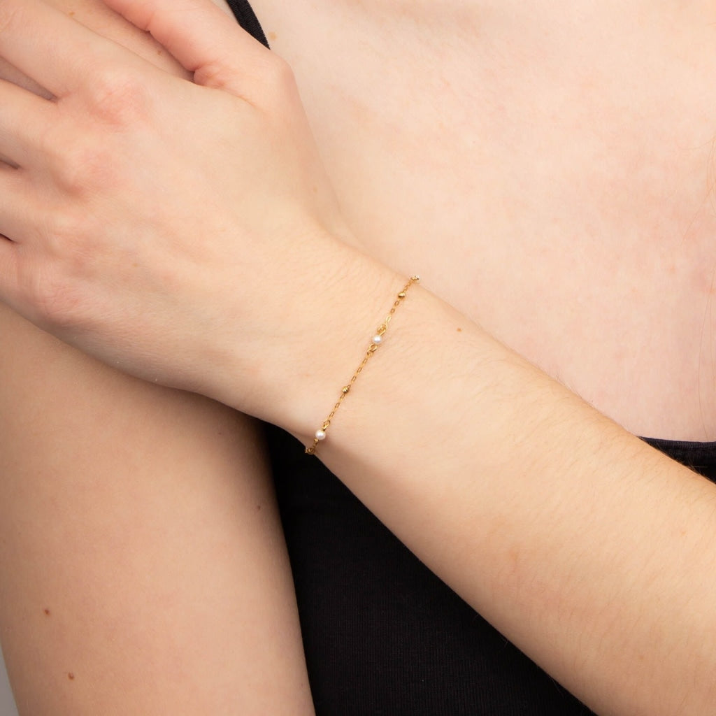 Hints of pearl bracelet on model