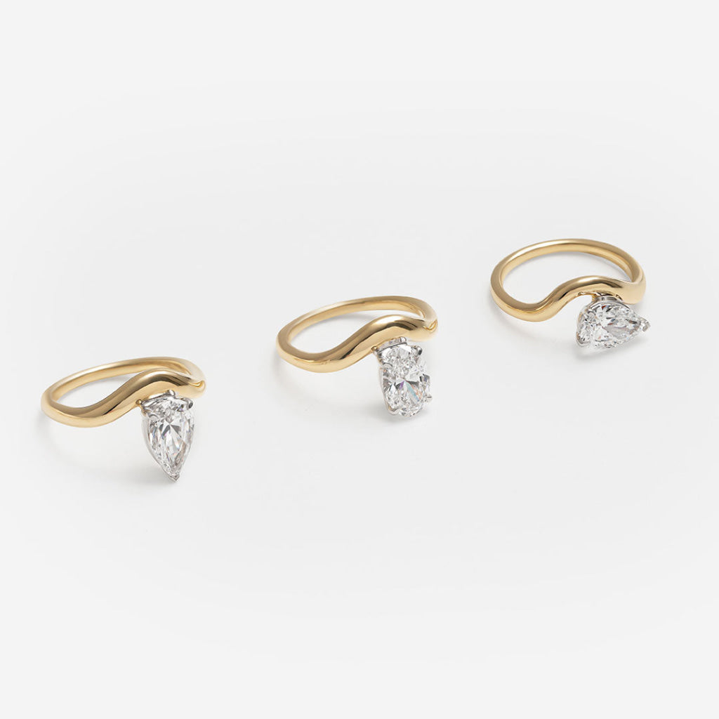 three curved band yellow gold rings