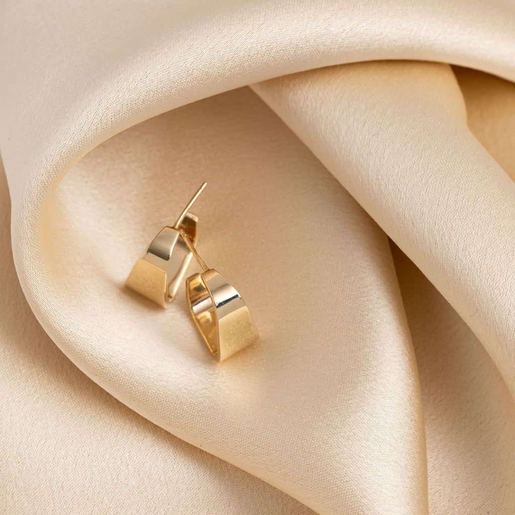 gold hoop earrings on fabric