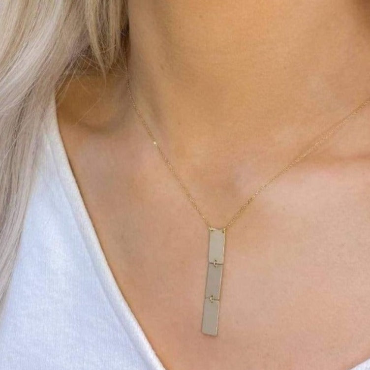 Woman wearing 9ct Gold triple bar Necklace
