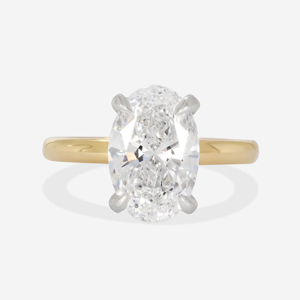 oval cut solitaire on yellow gold band
