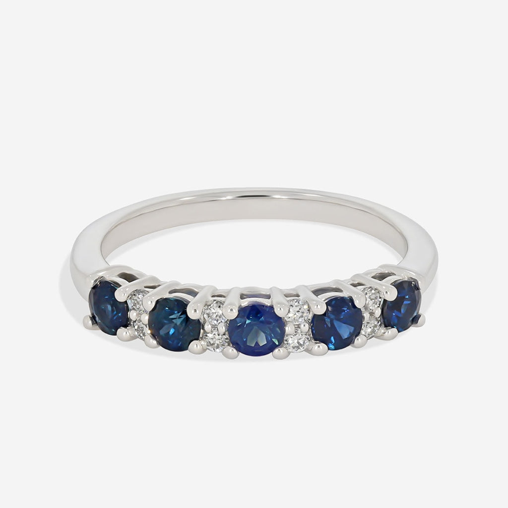 diamond and sapphire eternity ring on white background