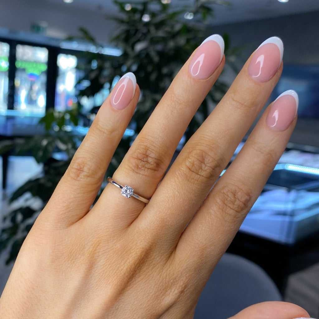 Diamond solitaire ring on lady's hand