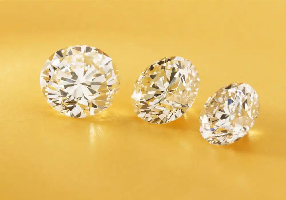 Three brilliant-cut diamonds arranged in a row.