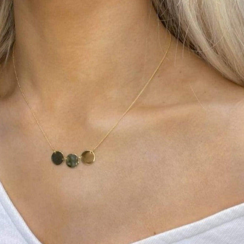Woman wearing 9ct gold Triple Disc Necklace.