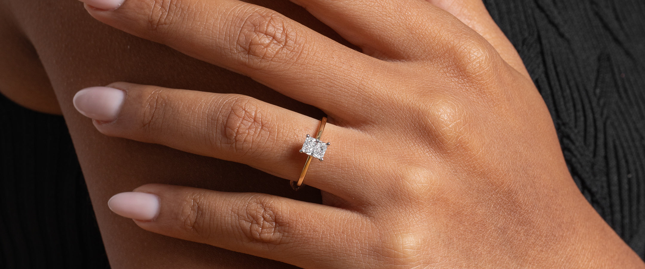 Woman's hand wearing a radiant cut diamond Engagement Rings by Gear Jewellers