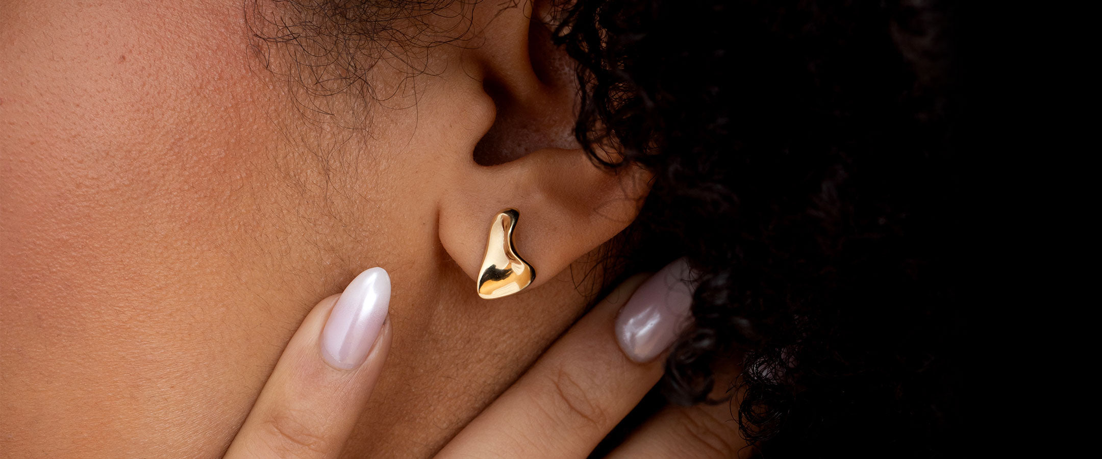 Woman wearing gold stud earring | Gear Jewellers Dublin