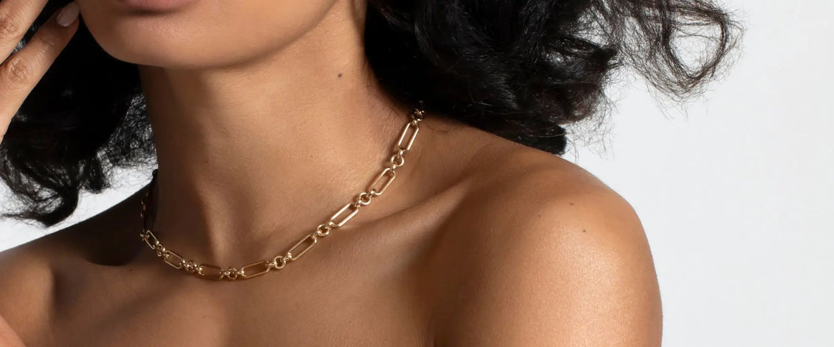 Model wearing a gold layering chain | Gear Jewellers Dublin