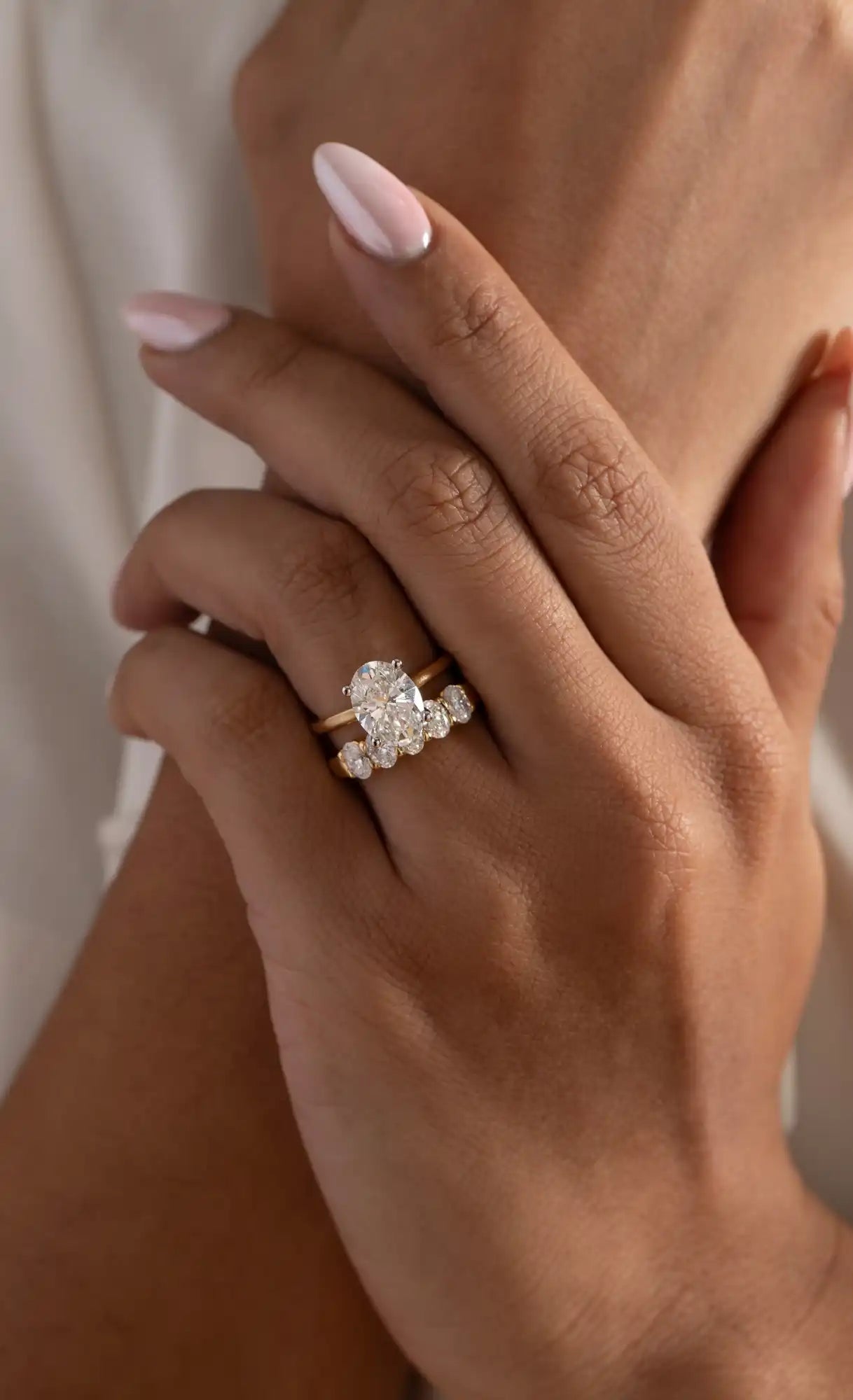 Gold ring with oval diamond and smaller stones.