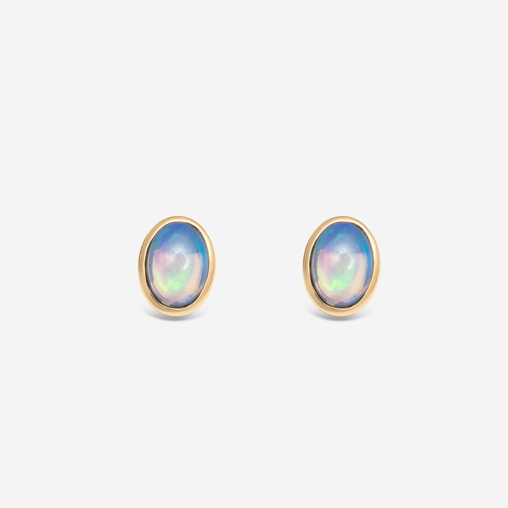 yellow gold opal gemstone stud earrings on white background