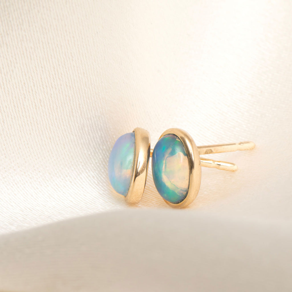 side view of yellow gold opal gemstone earrings