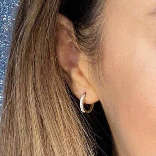 Woman wearing 9ct gold CZ Huggie Earrings | Gear Jewellers Dublin