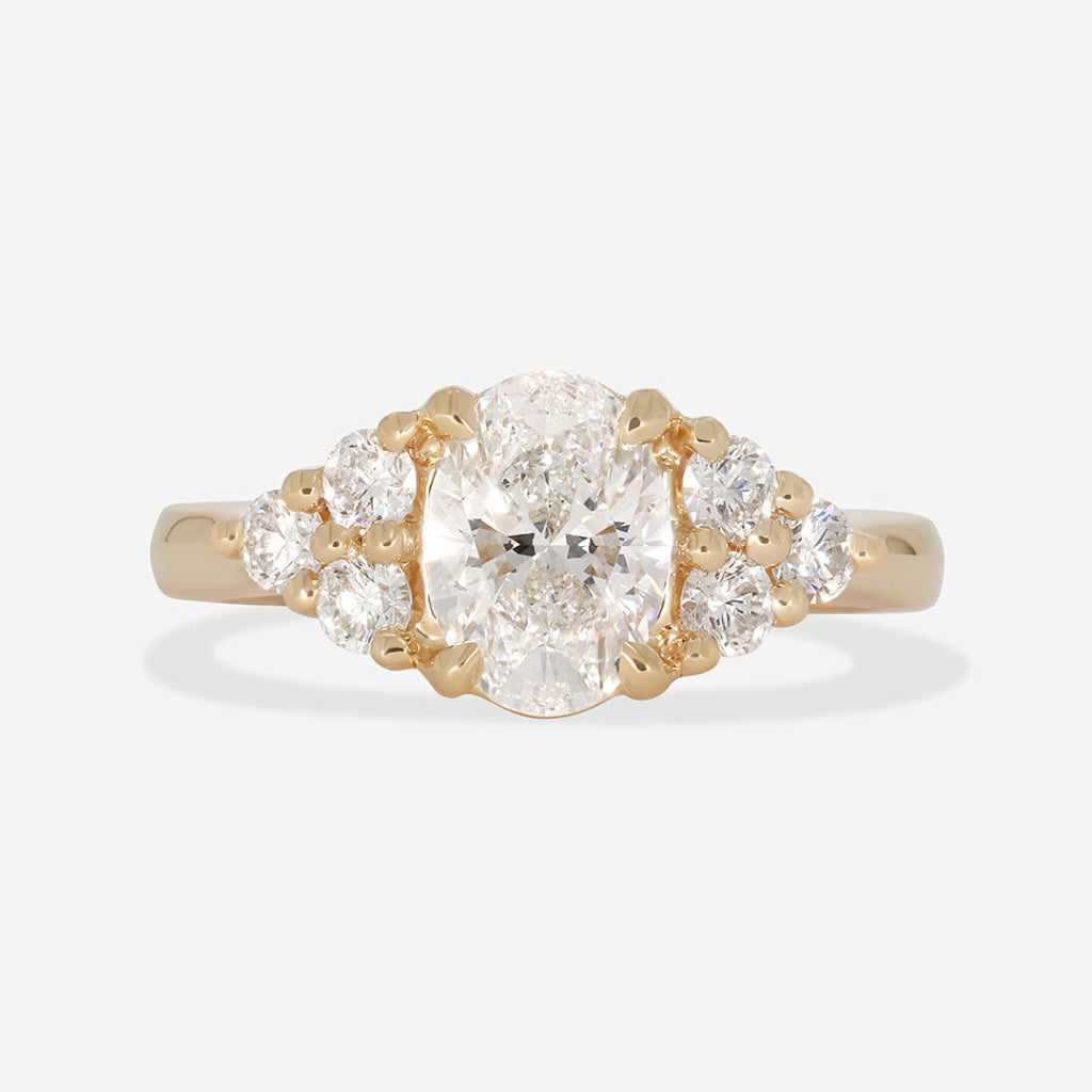 oval engagement ring with round diamond side diamonds 