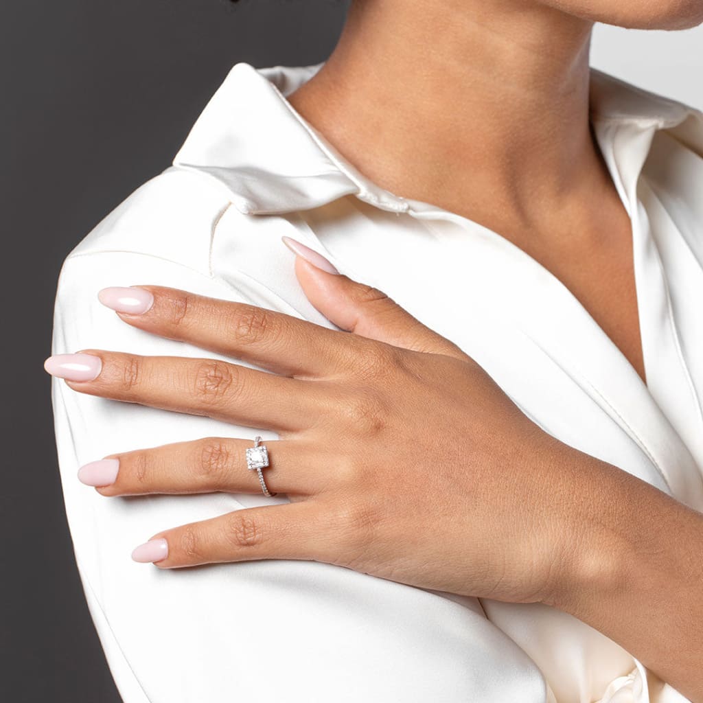 Woman holding her hand on her shoulder wearing the Amber Ring