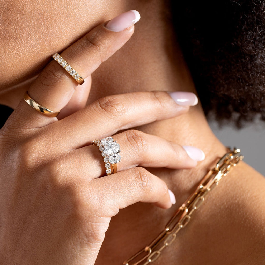 Woman wearing several diamond & gold rings - photo 1