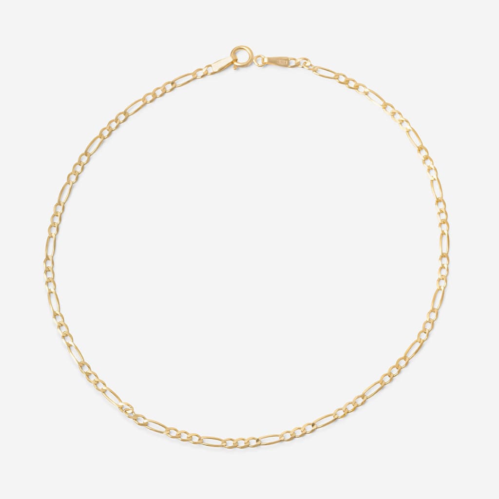 yellow gold figaro style anklet on white background