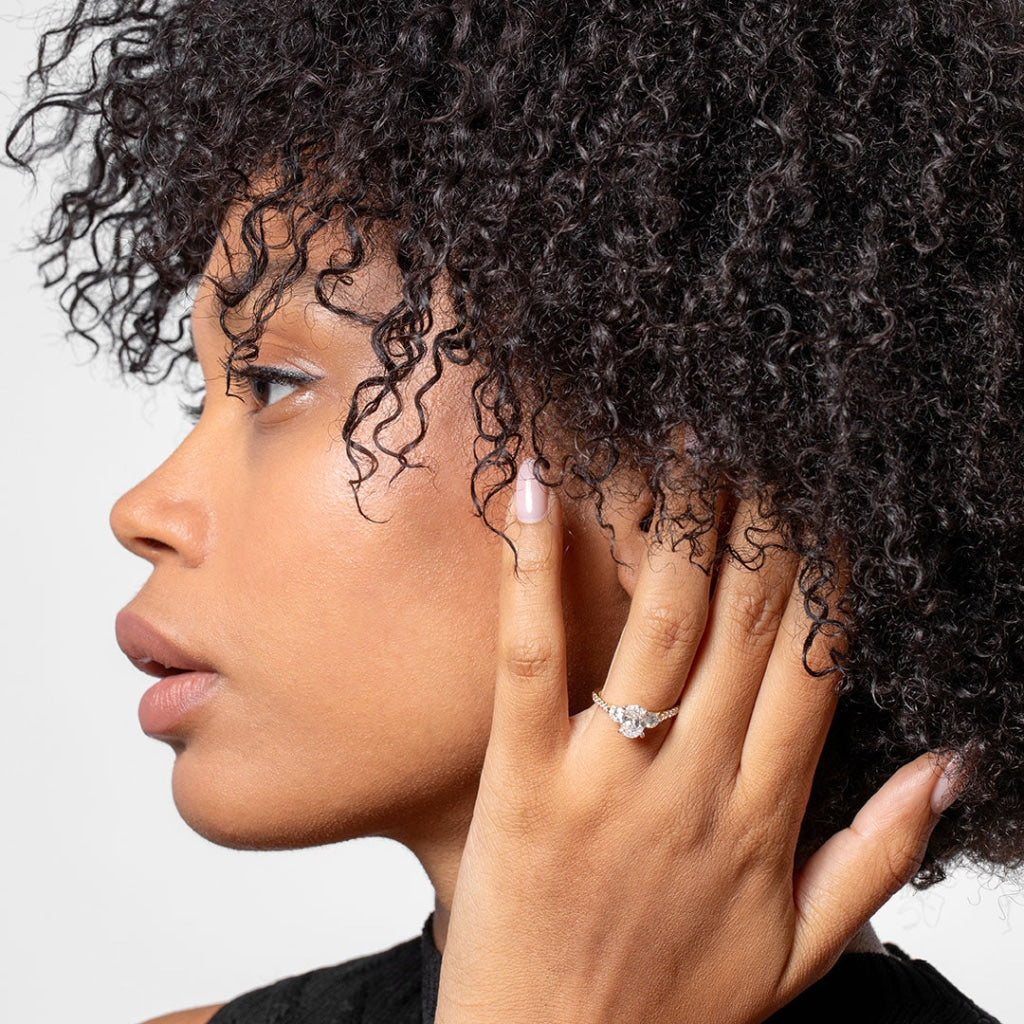 Woman with dark curly hair wearing Aphrodite Diamond Engagement Ring