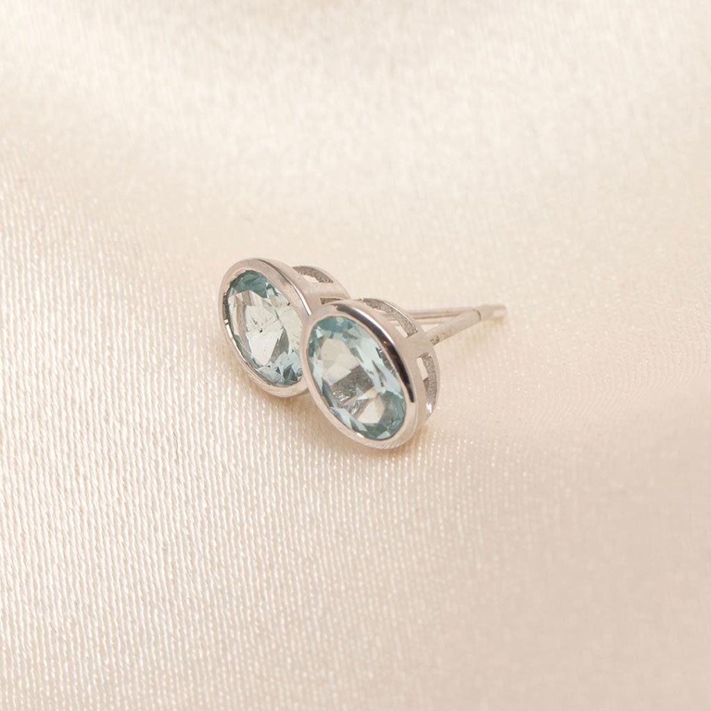 side view of aquamarine white gold bezel set earrings