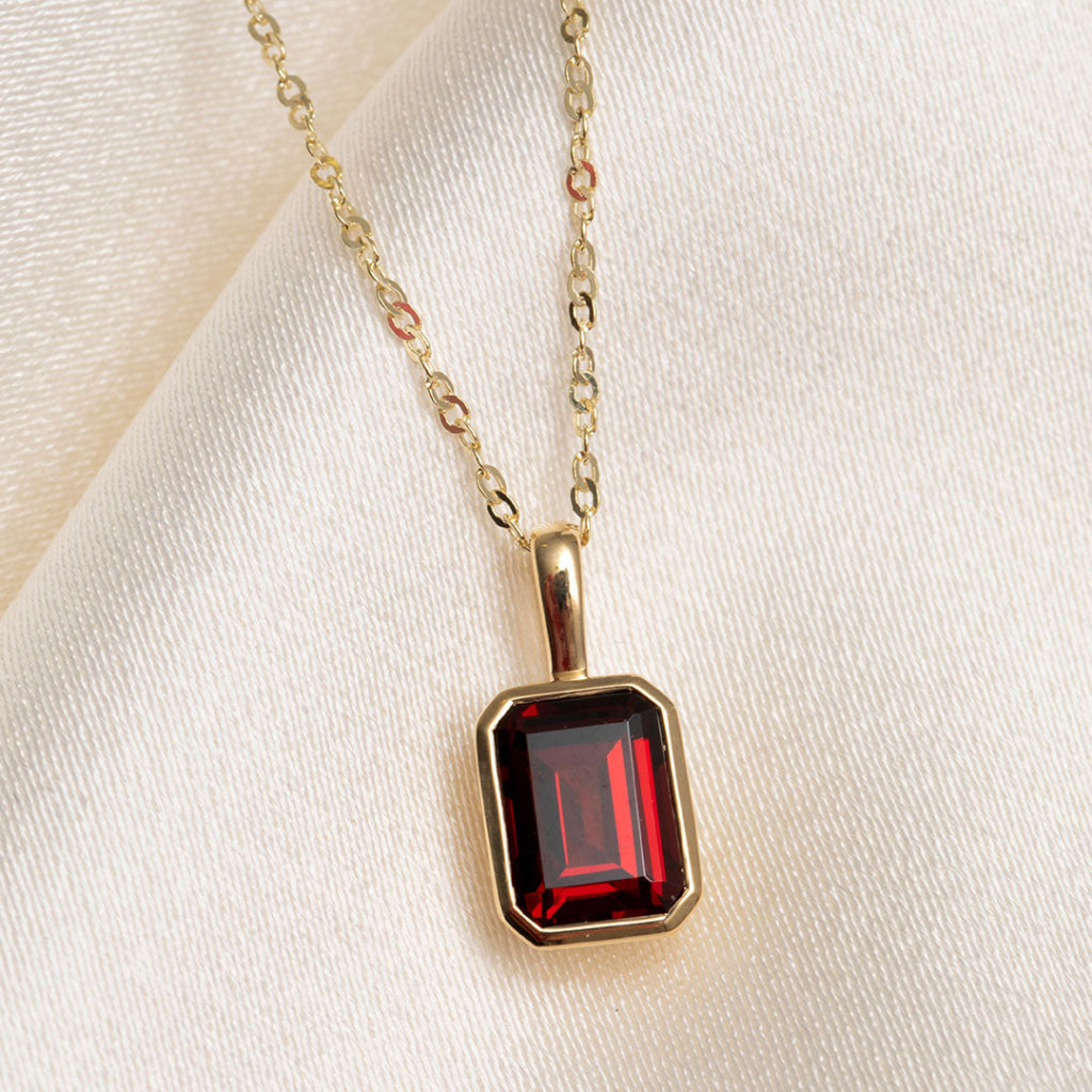 bezel set garnet gemstone pendant on chain