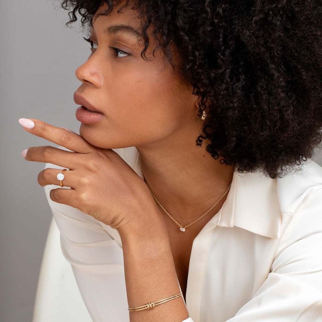 Model wearing auric round gold diamond engagement ring