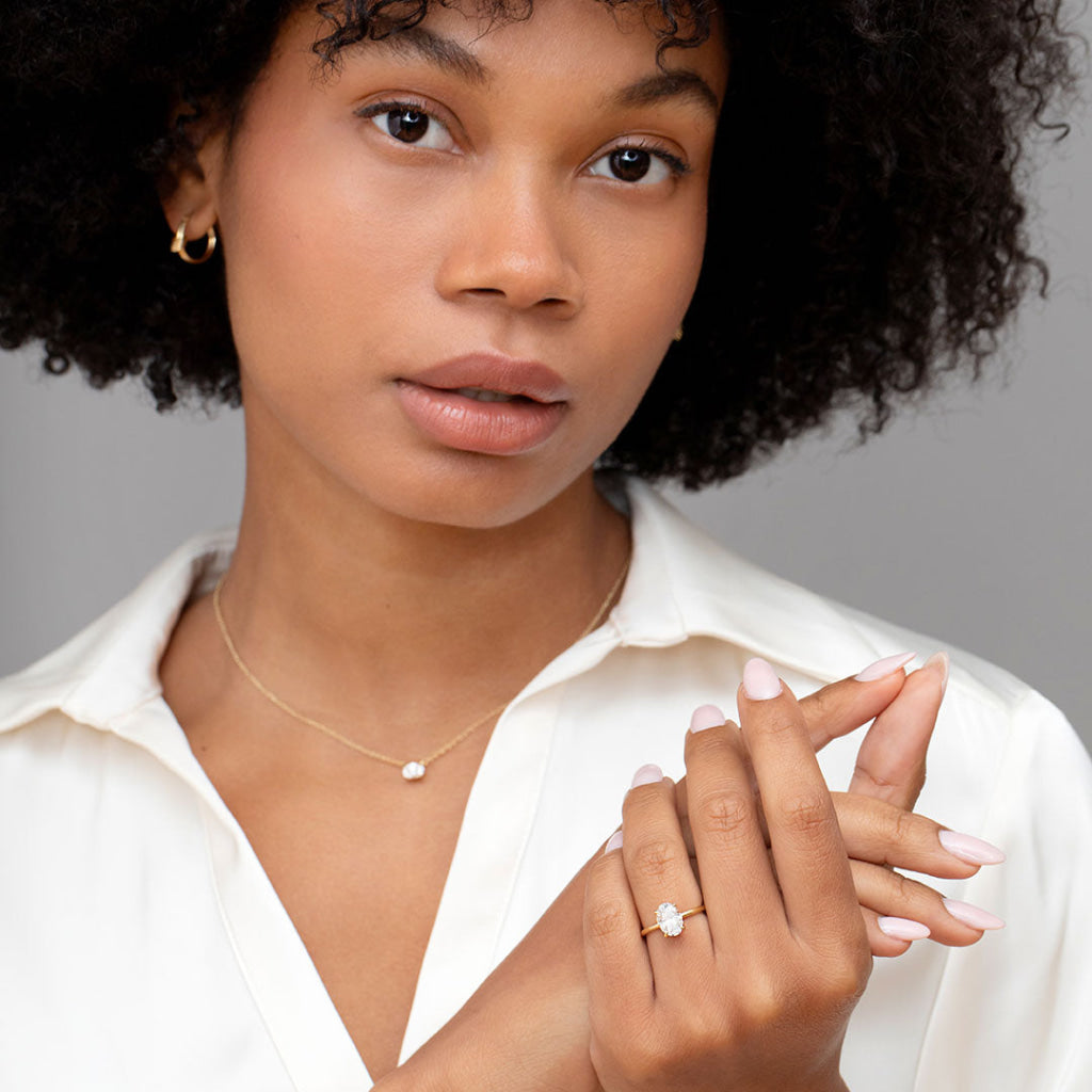 Lady wearing gold oval engagement ring - Boyne