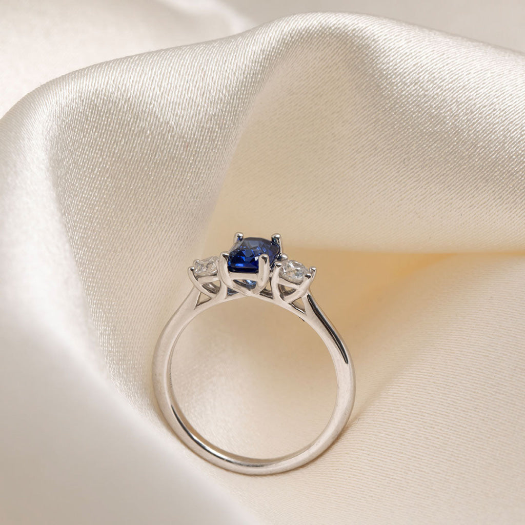 emerald cut sapphire three stone engagement ring