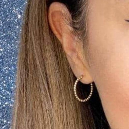 Woman wearing 9ct gold Beaded Hoop Earrings | Gear Jewellers Dublin