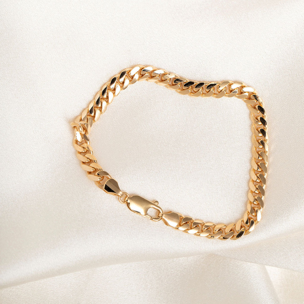 gold curb bracelet on fabric