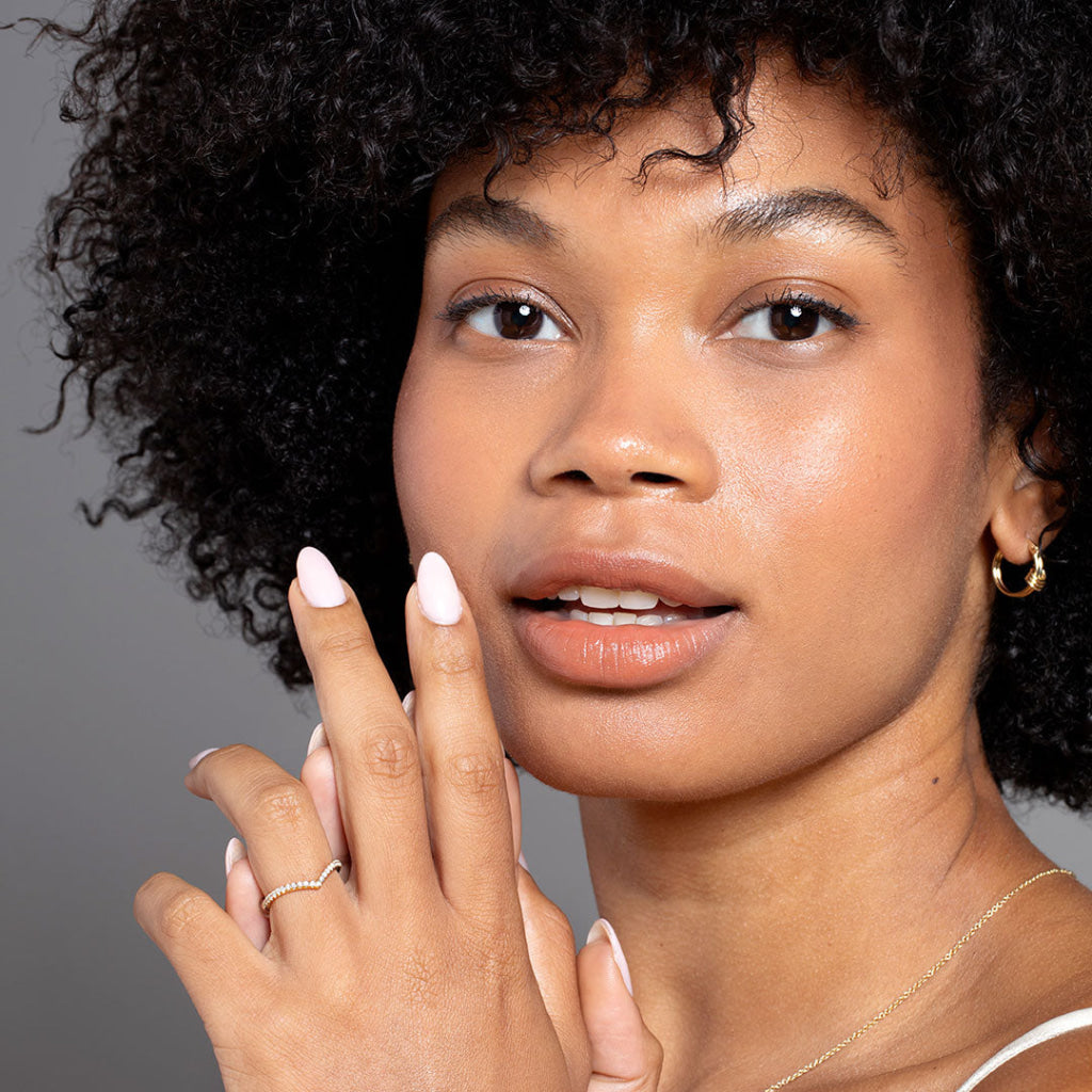 Close up model wearing curved diamond band