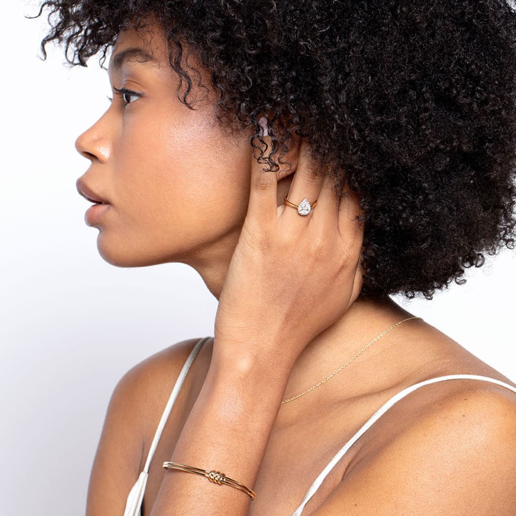 Model wearing pear diamond engagement ring