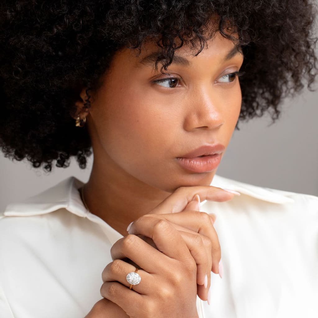 model wearing gold diamond engagement ring