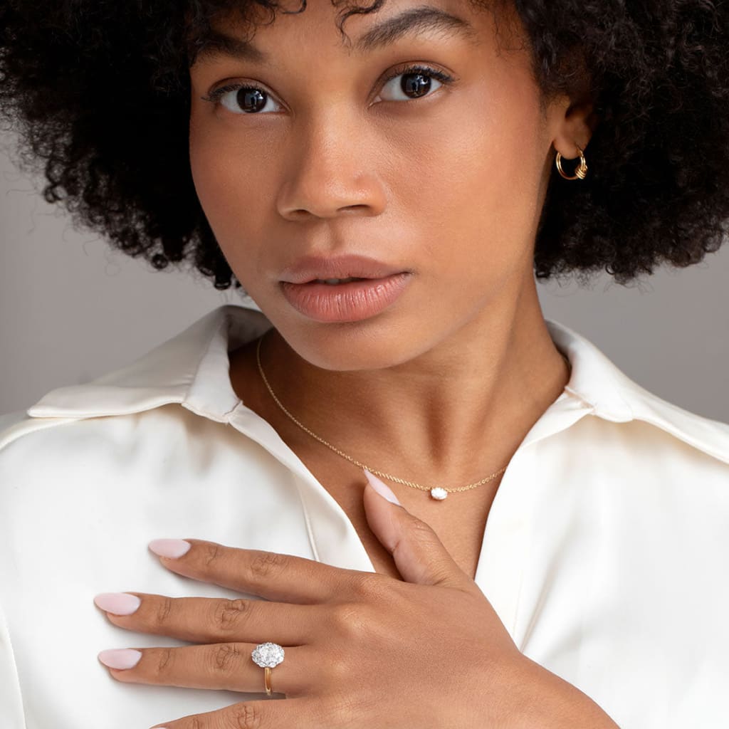 Hand model wearing engagement ring