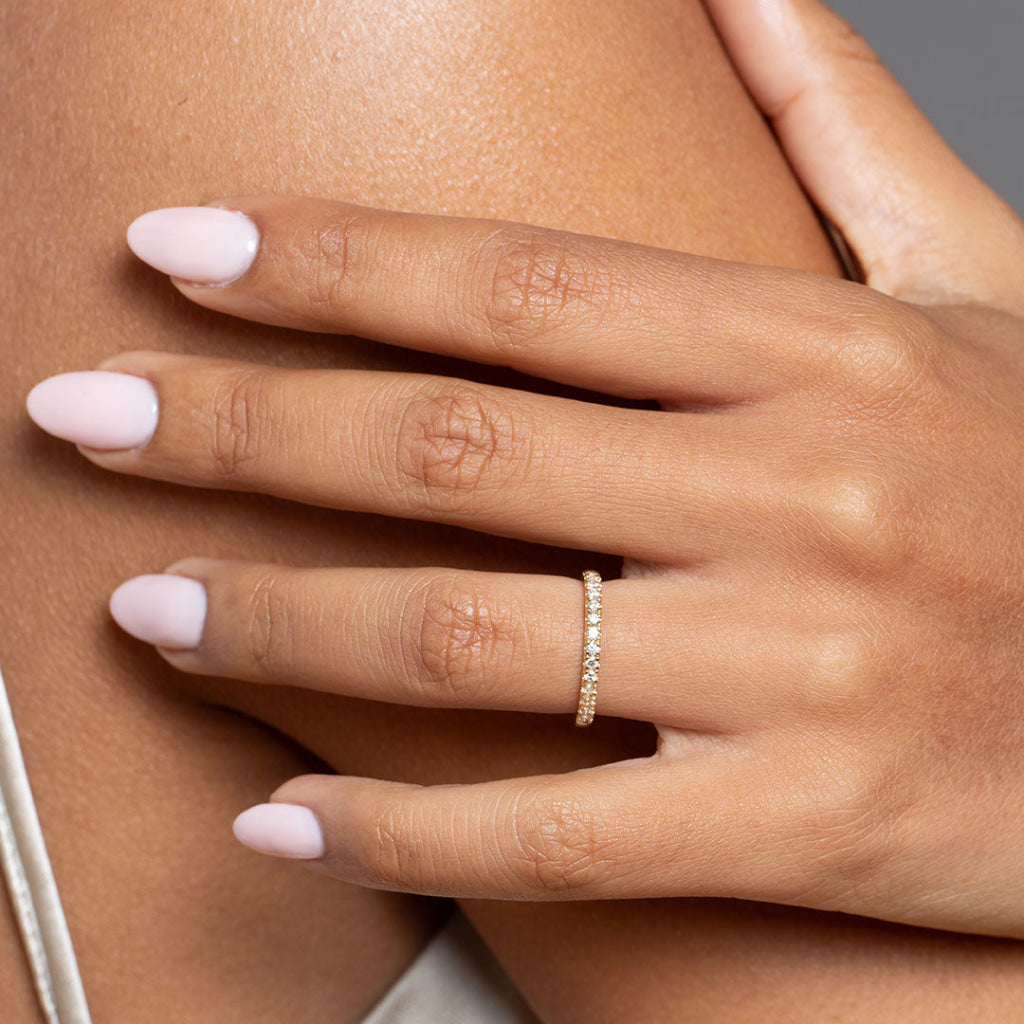 Model's hand wearing Castille Gold Diamond Wedding Ring