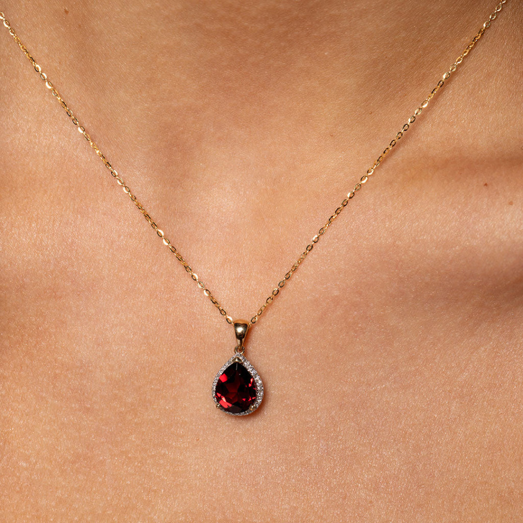 Up-close image of garnet necklace on model 
